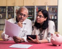 Senior couple reviewing documents and planning for the best old age home in Delhi — Saral Satya Legacy