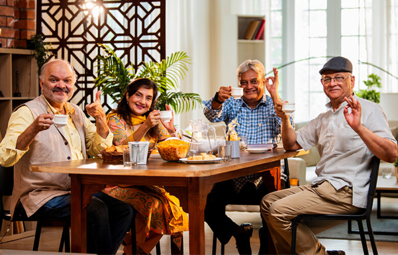 Group of seniors enjoying tea together at a dining table, reflecting social and community life in rental retirement homes at Saral Satya Legacy.