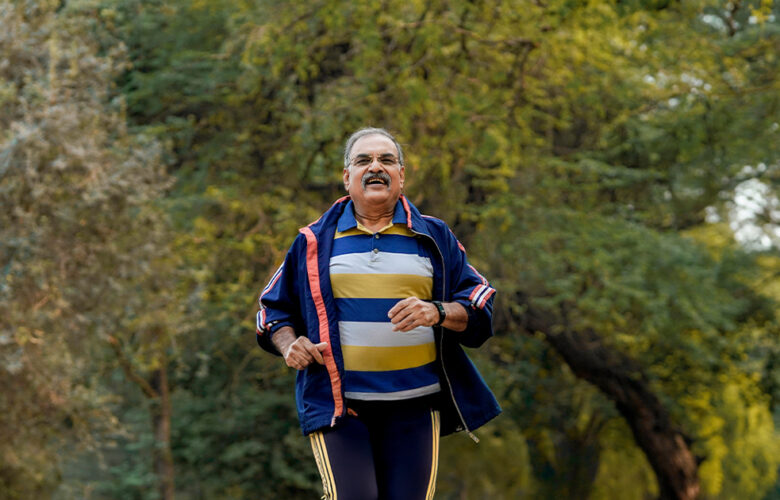 Senior man jogging in a park, demonstrating active lifestyle habits that support healthy ageing.